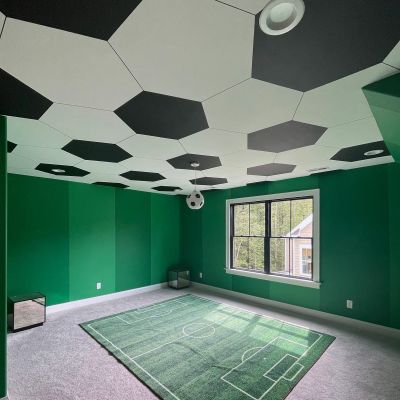 A Complete View Of A Customized Playing Room Made Up Of A Football Theme, With A Football Ground-Shaped Carpet