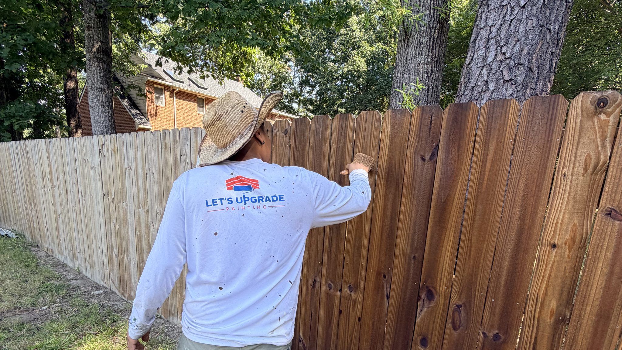 Wood Privacy Fence Half Stained By A Painter