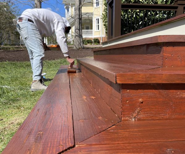 Painter Staining Deck Steps A Rich Brown