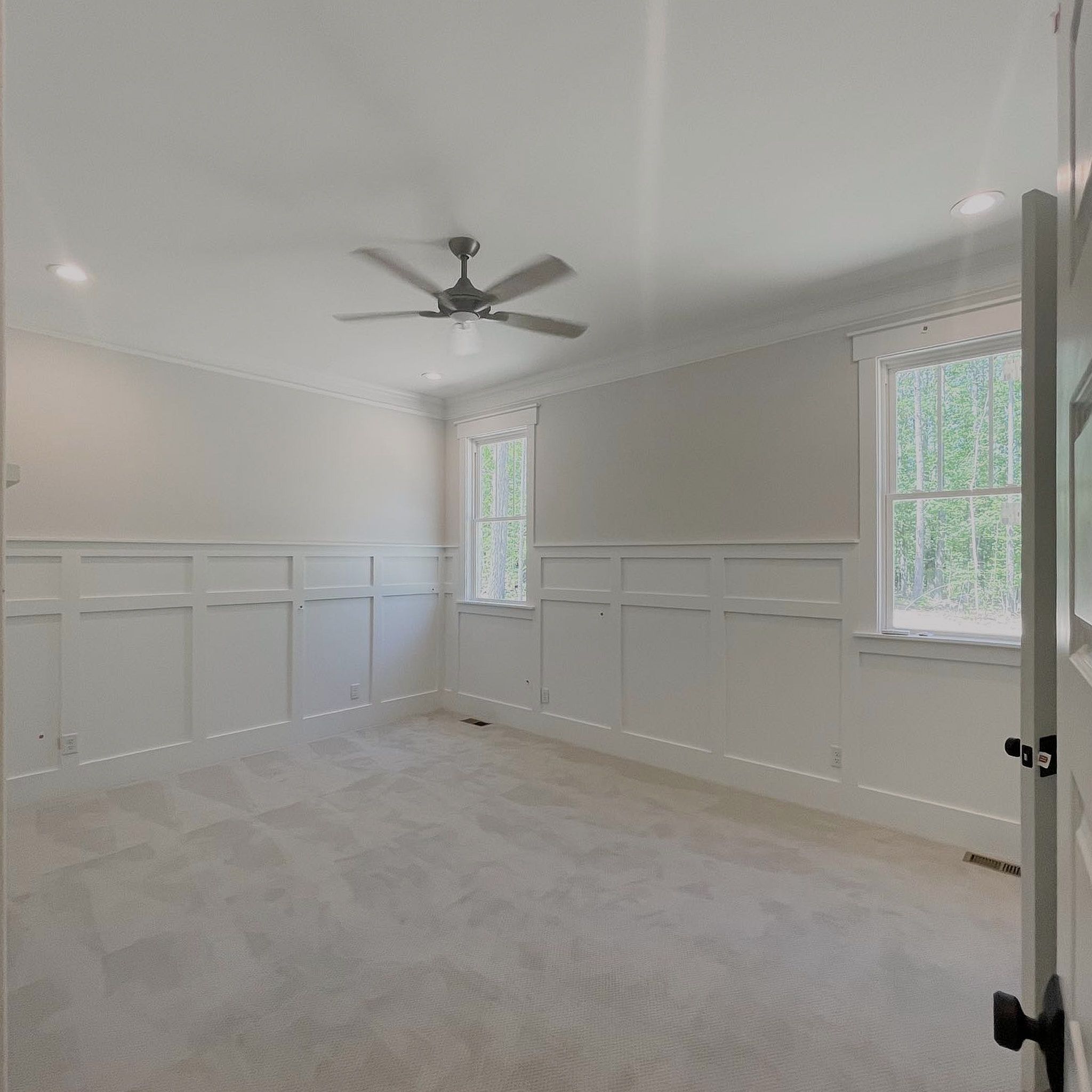 A Two Wall View Of A Well Painted Room In White Color With Marble Tiling And White Wooden Glass Slider Windows