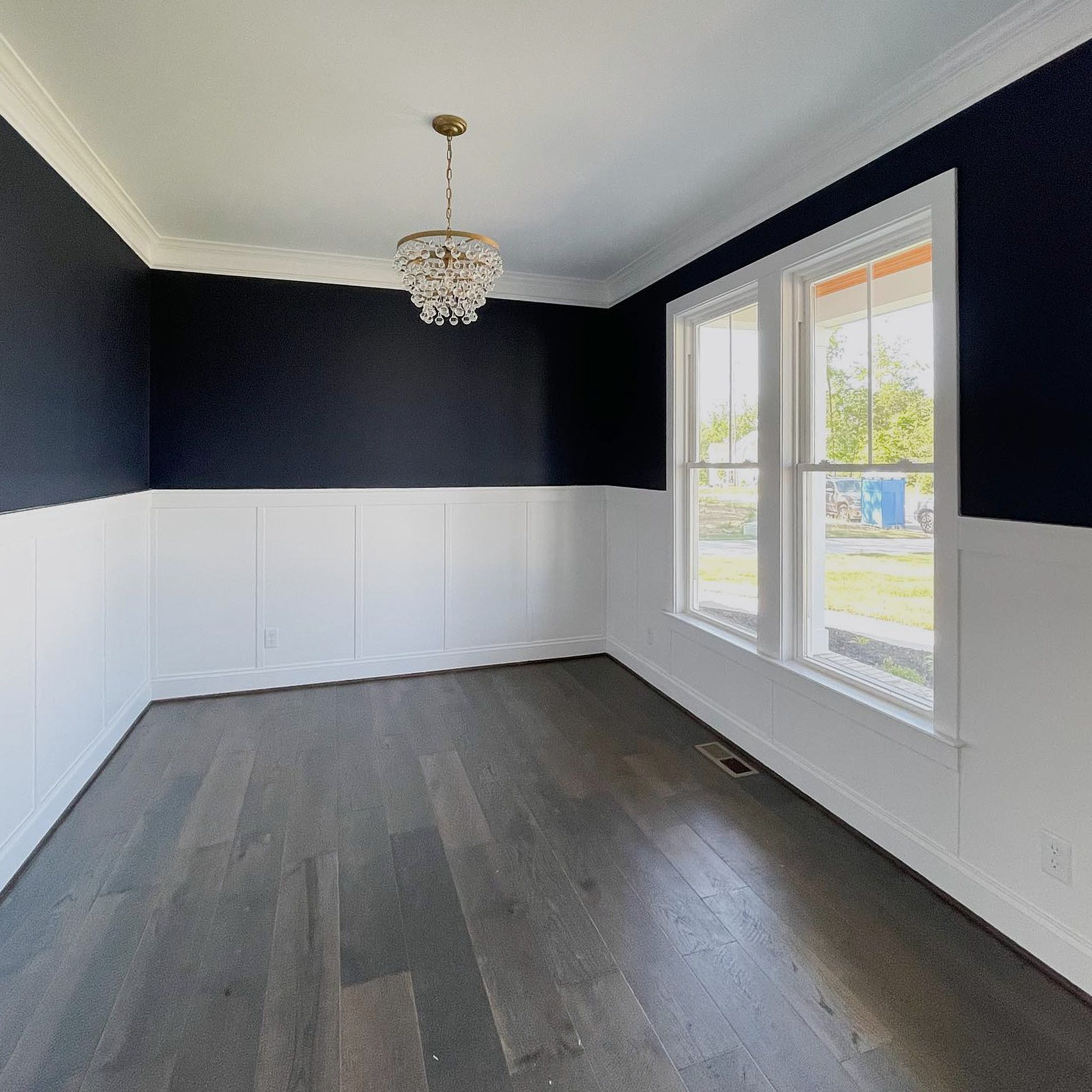 Small Room With White Paint On The Bottom Border And Black On The Upper One And A Couple Of Slider Windows