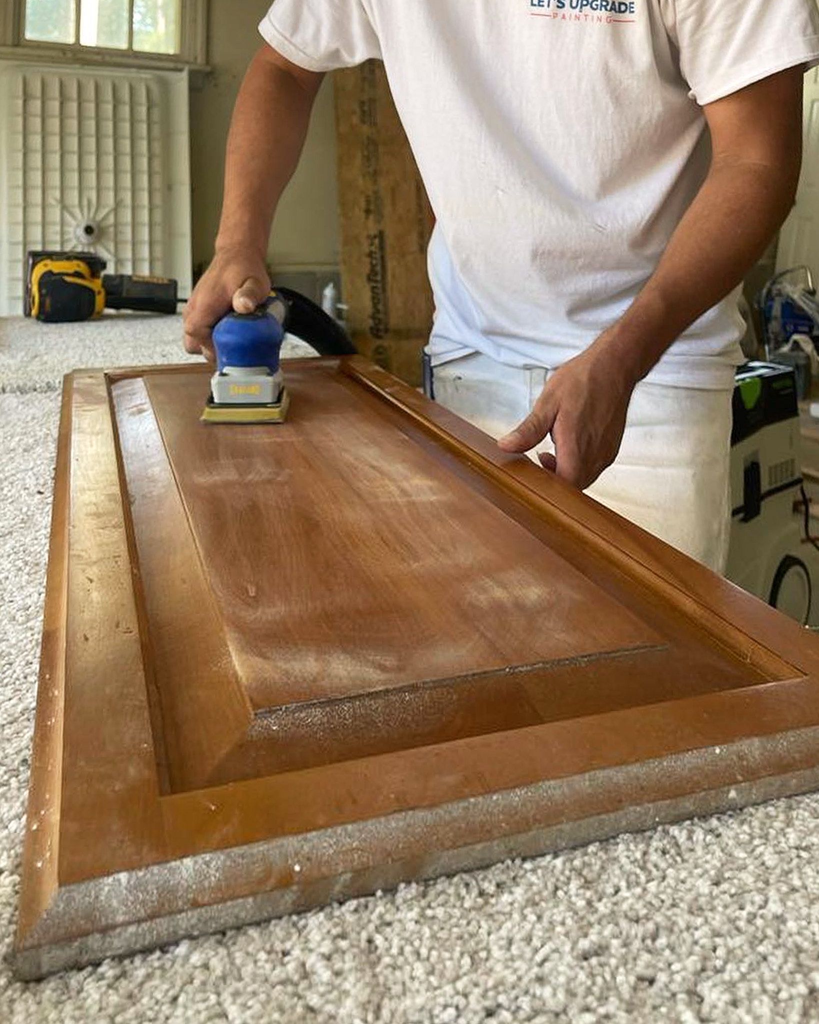 Preparation By Employee With Sander For Kitchen Cabinet Door