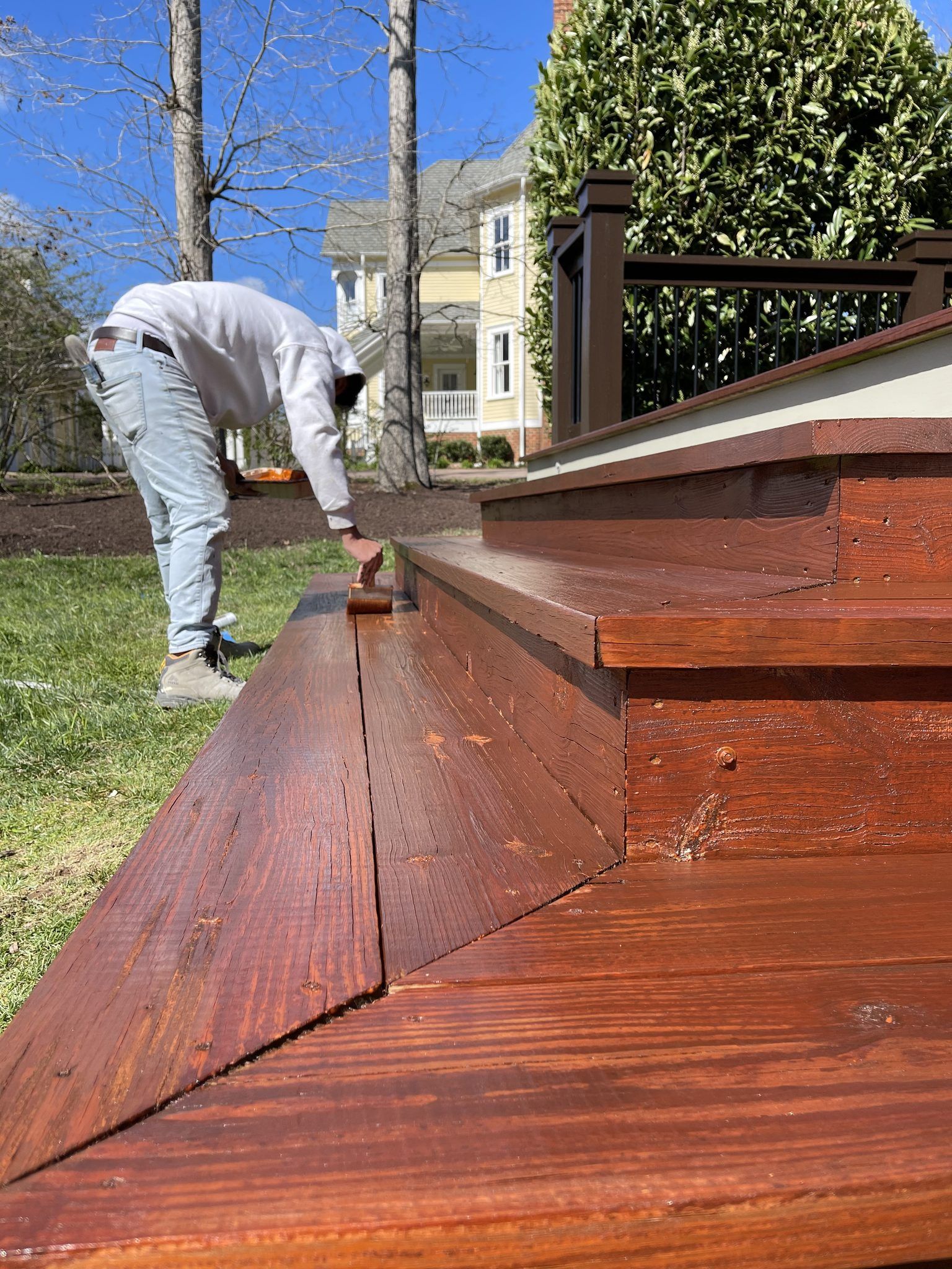 Painter Staining Deck Steps A Rich Brown