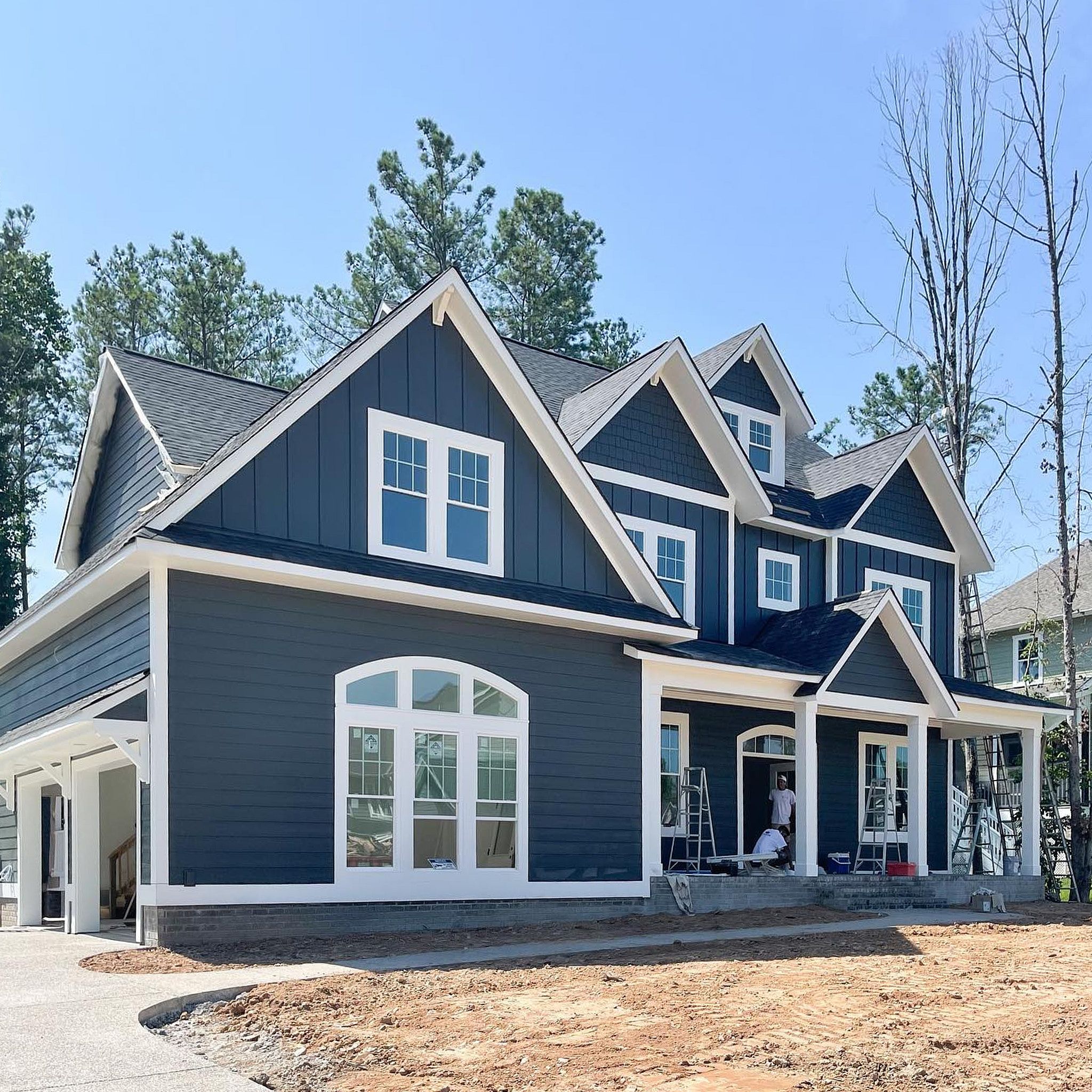 Full Outside View Of A Beautiful House Painted Professionally In Dark Navy And White Colors