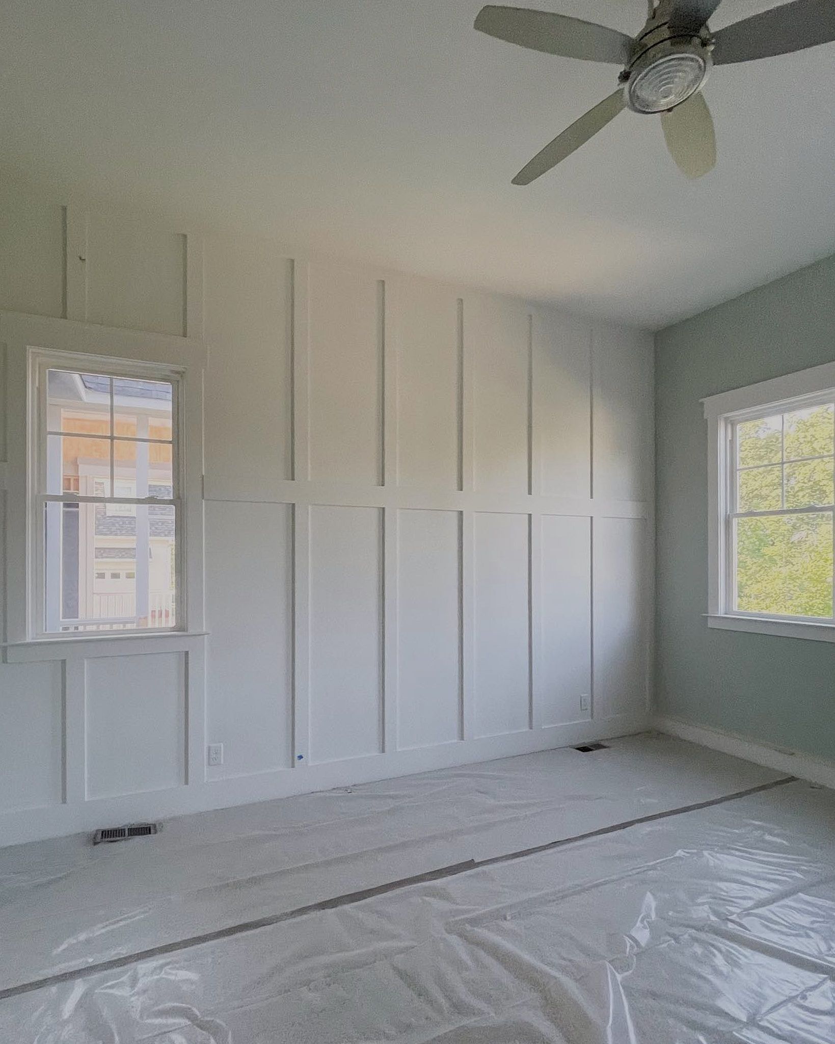 Rectangular-Shaped Boxes Pattern On The Wall Painted White Inside A Room With Other Walls Painted In Light Green