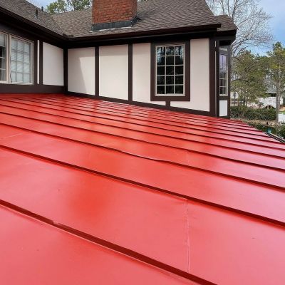 Mansard Roof Of A House Painted In Shiny Red Color, Showcasing The Vibrant Paint