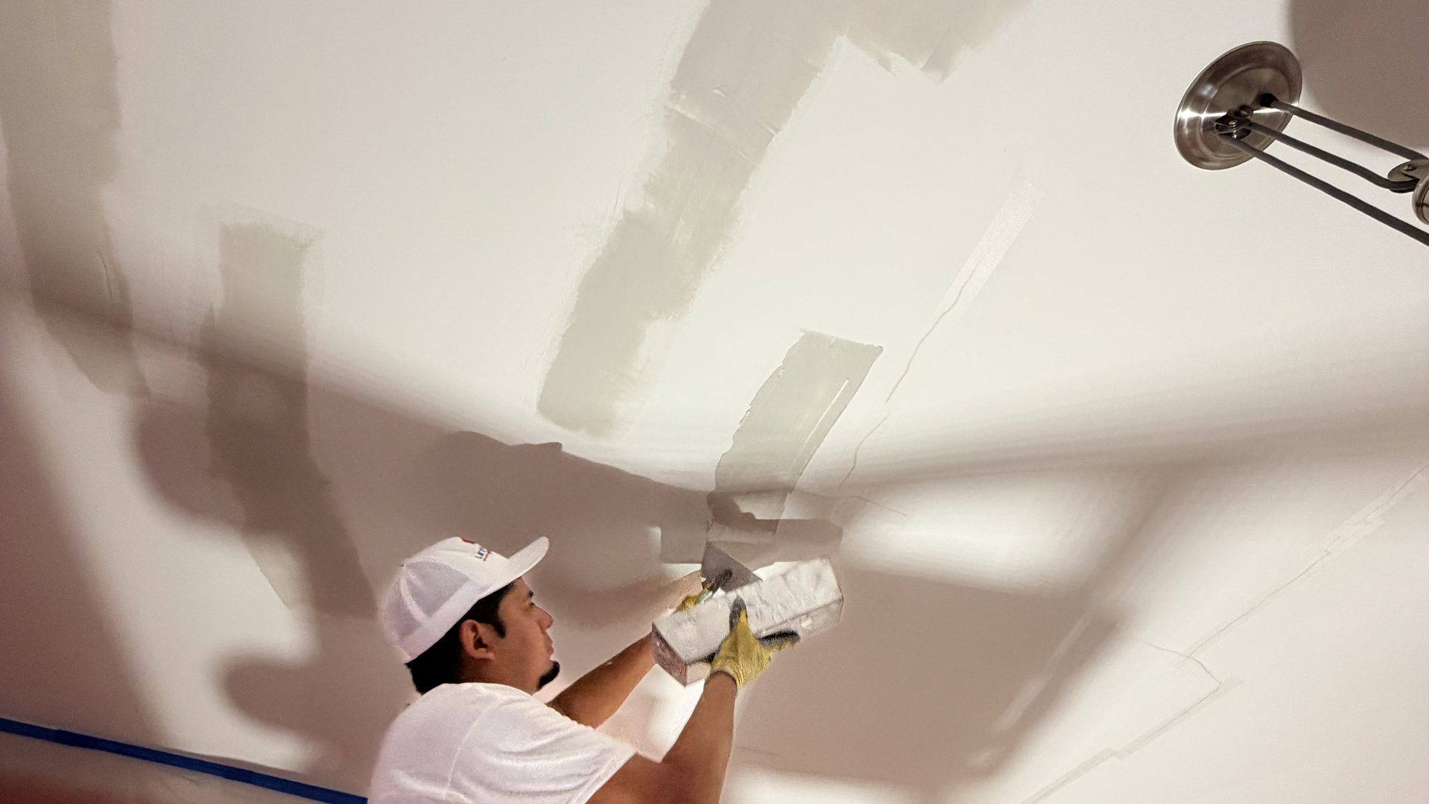 Painter Skim Coating A Ceiling Smooth