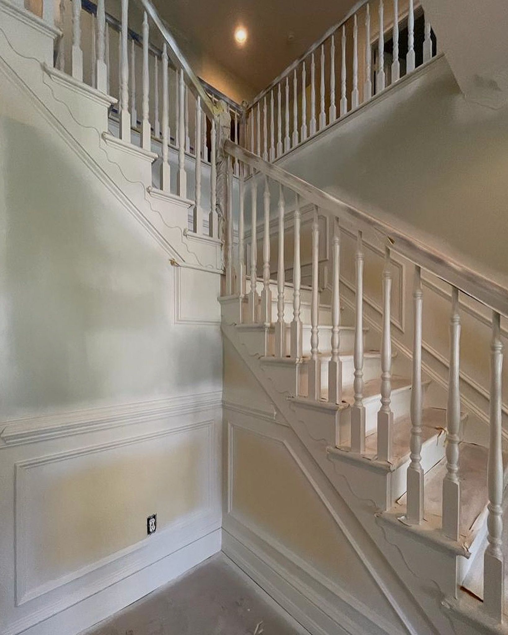Retro-Style White Stair Railings With Cream And Dull Green Lighter Patches On The Wall
