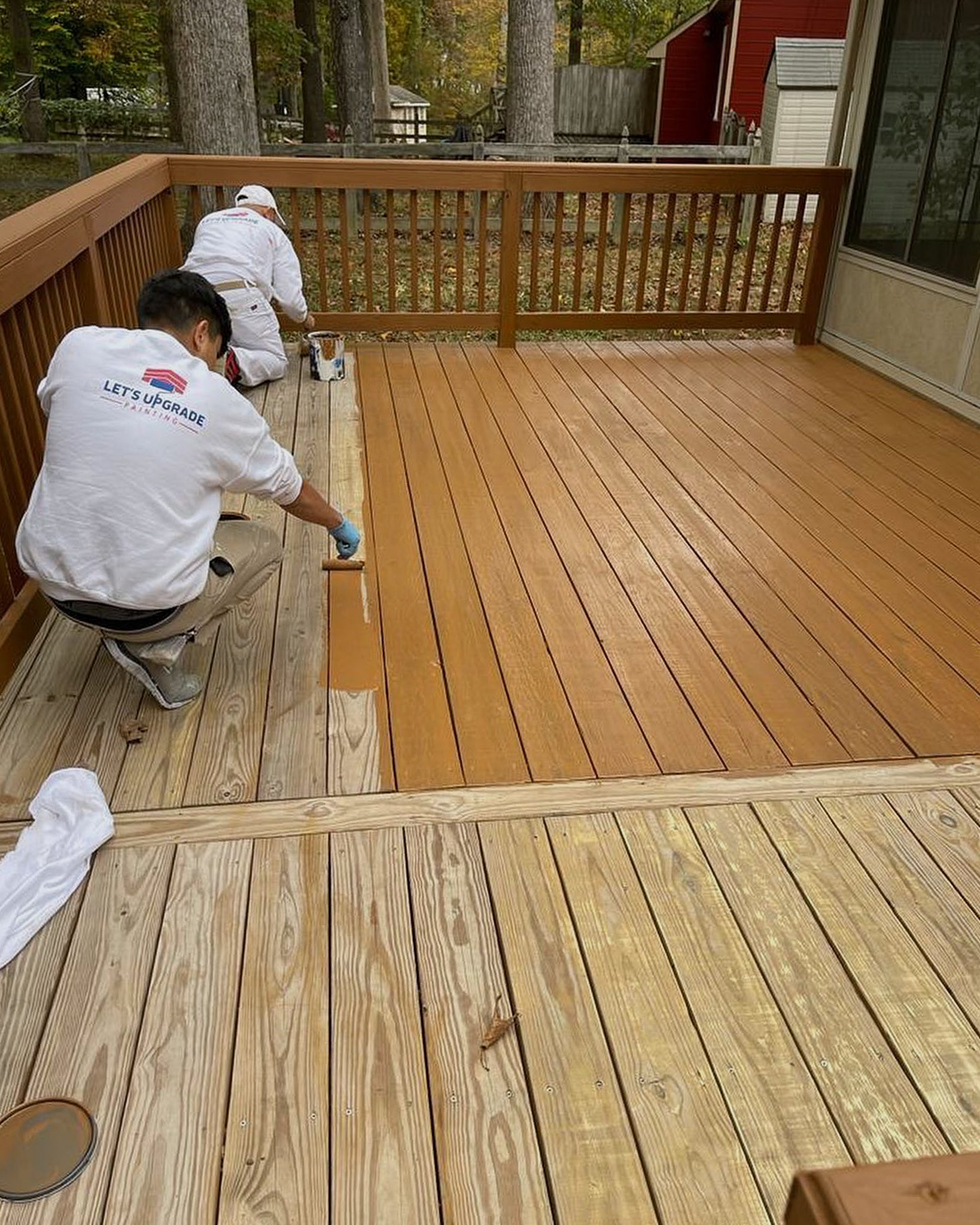Let's Upgrade Painting Employees Rolling Deck Boards With Deck Stain