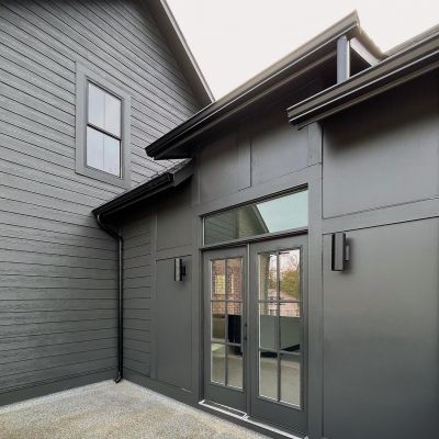 A View Of A House Form Outside Painted Very Cleanly In The Graphite Color - Lets Upgrade Painting