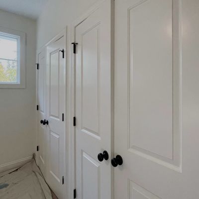 Multiple Wooden Doors Painted In White Color, Aligned Closed In A Series