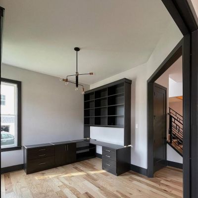 Living Area Inside A House With Light-Colored Walls, Clean Marble Flooring, And Black Color Borders Painted On Every Corner