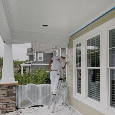 A Professional Worker Of Lets Upgrade Painting Busy In Painting The Outer Walls Details Of The House