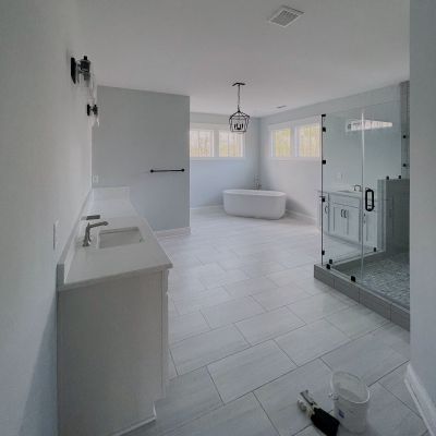Long View Of A Newly Painted Spacious Residential Bathroom With An Attached Shower, Bathtub, And More